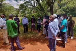 Prof. David Mungai, Director, WMI, with WMI PhD and MSc students discussing the impact of riparian zone encroachment by human settlements and agricultural activities at the CAVS dam (Field Station) on March 19, 2021