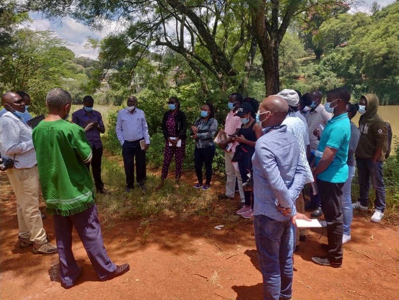 Prof. David Mungai, Director, WMI, with WMI PhD and MSc students discussing the impact of riparian zone encroachment by human settlements and agricultural activities at the CAVS dam (Field Station) on March 19, 2021