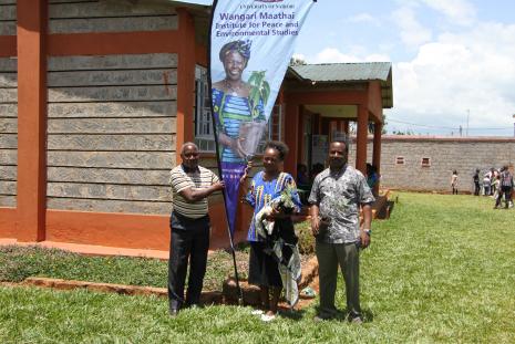 A woman who attended Wangari maathai day 2024 at Kibugu, Embu St Charles Lwanga tenderly holding a seedling provided by WMI to go and plant on her farm to mark Wangari Maathai Legacy. Next is Prof Thenya, Director WMI and left is a local church elder Mr. Mugo